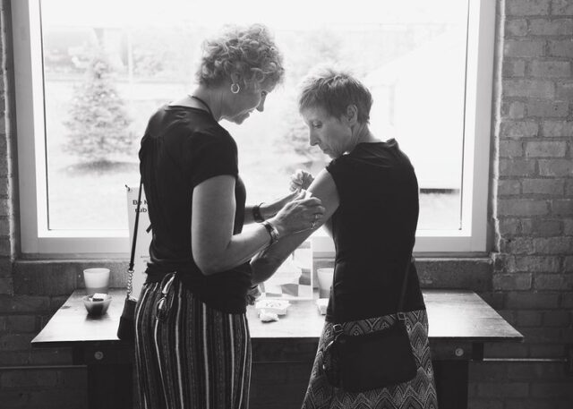 Guests placing temporary tattoos in honor of the person being celebrated