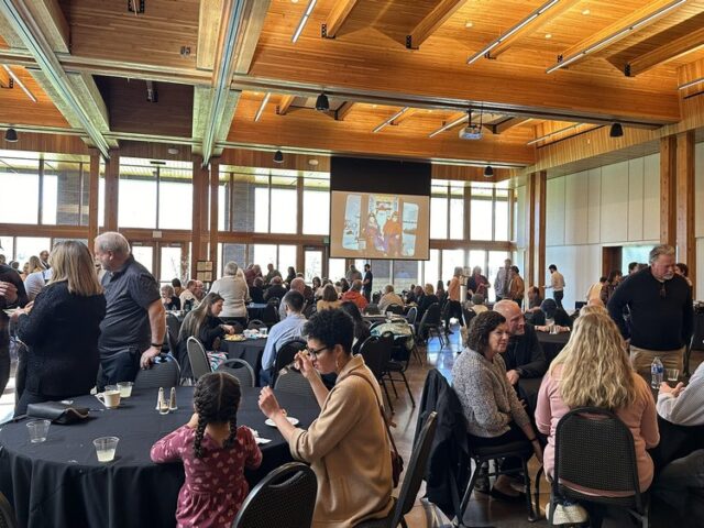 Mingling and watching a tribute slideshow at the Vadnais Heights Commons